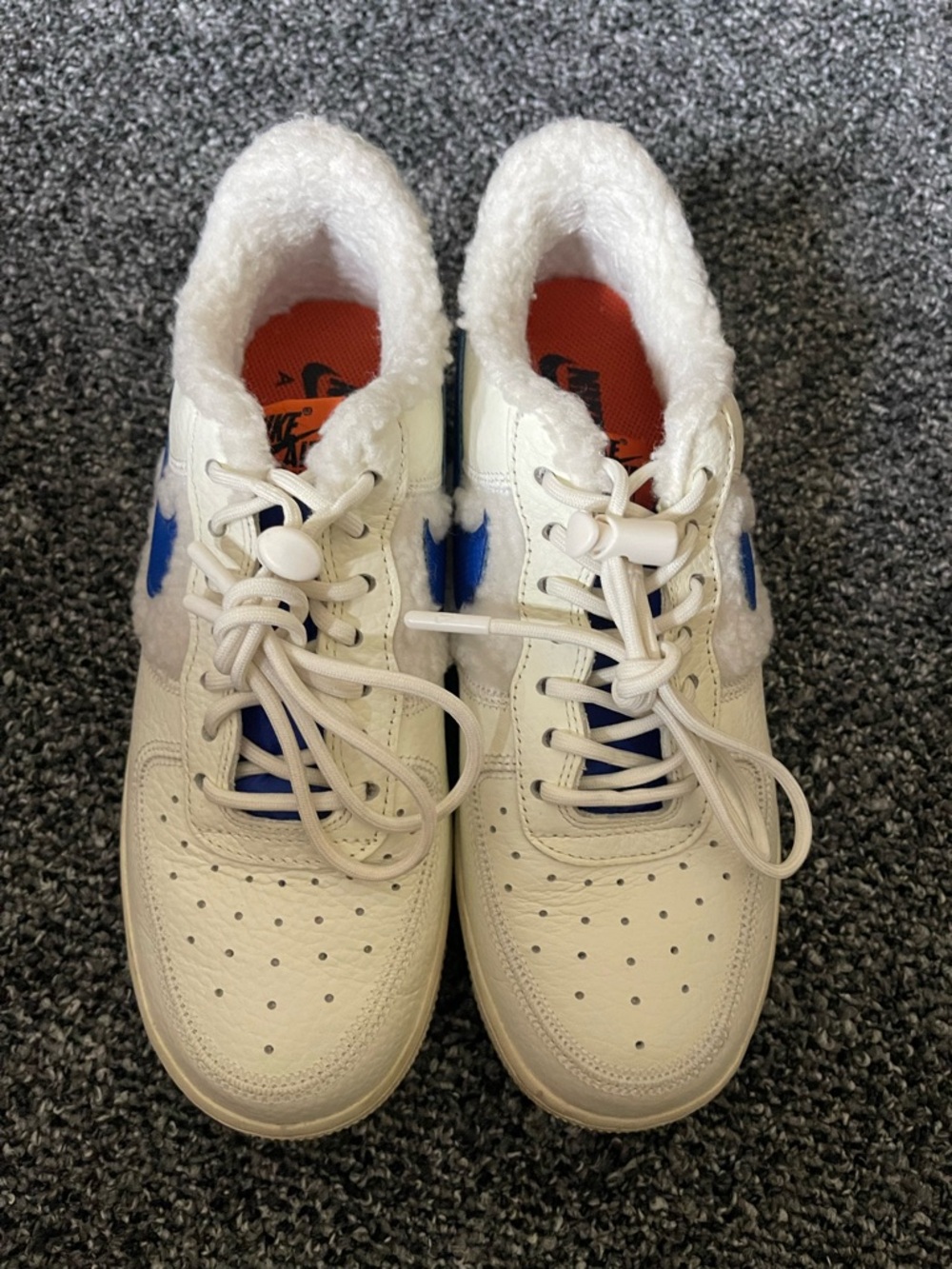 White Sneakers with Blue Swoosh Detail